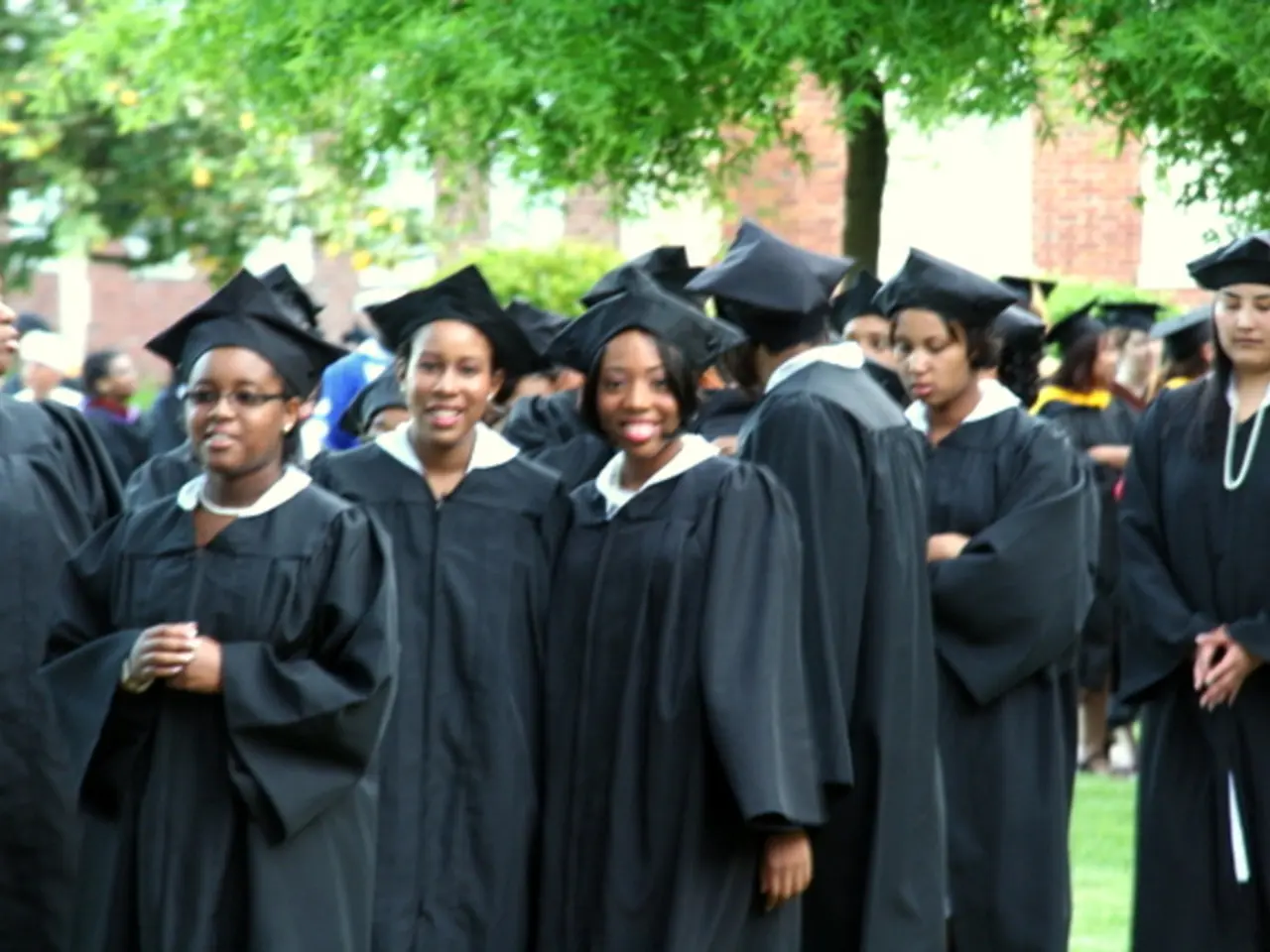 In the foreground of this image, there are women standing in convocation dresses and convocation...