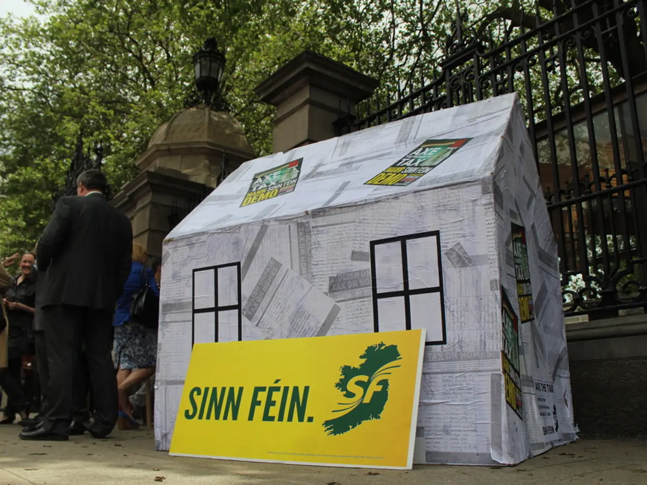 In the middle of the image we can see a tent placed on the floor and an advertisement board placed...