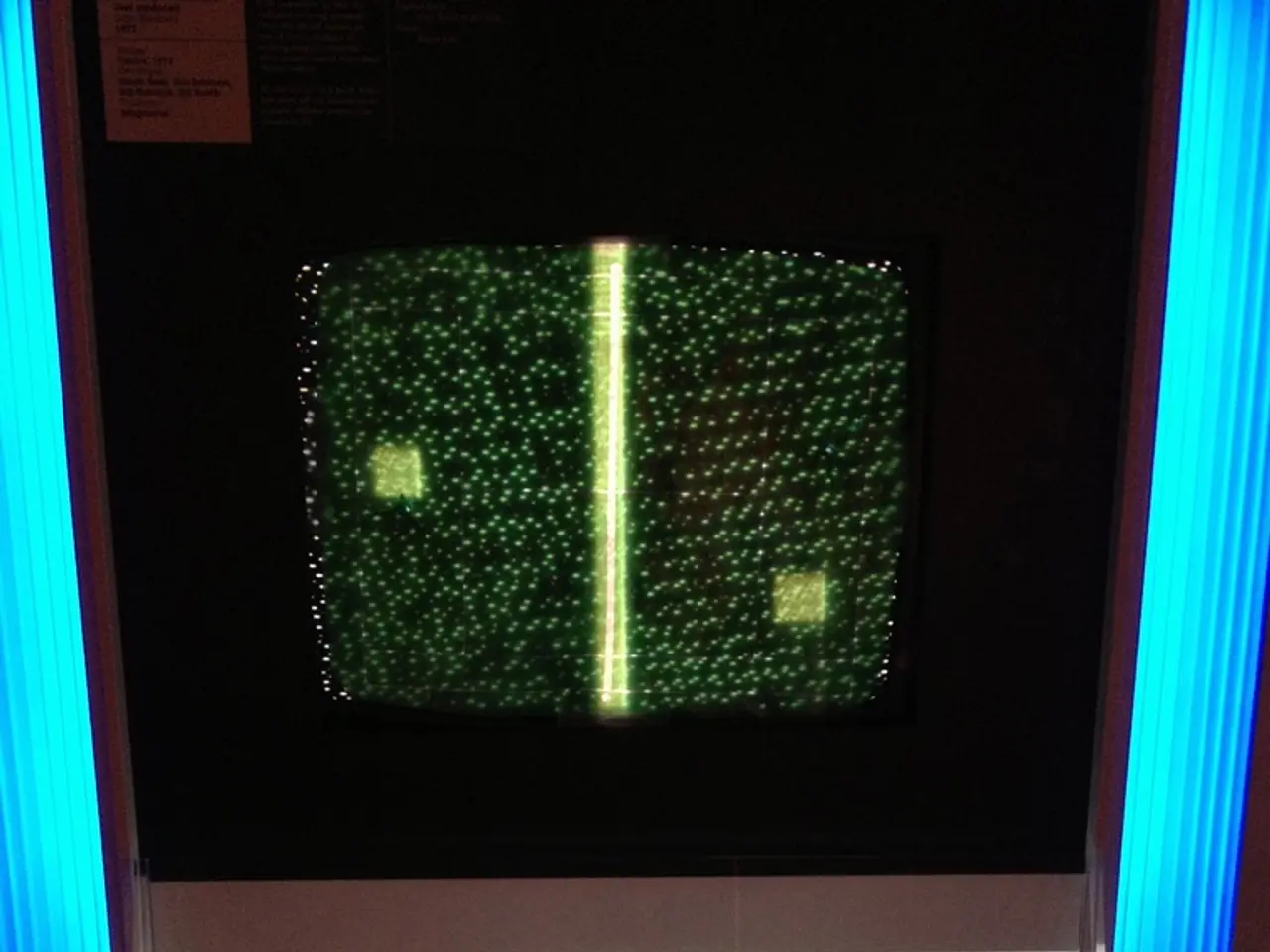 In this image there is a television in a cupboard, there are electronic devices, cables, papers,...