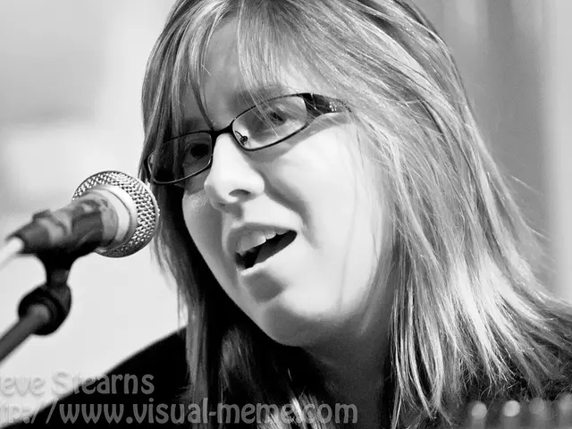 In the picture I can see woman is talking in front of microphone.