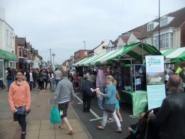 Here some people are standing and some are waking, these are houses, this is sky.