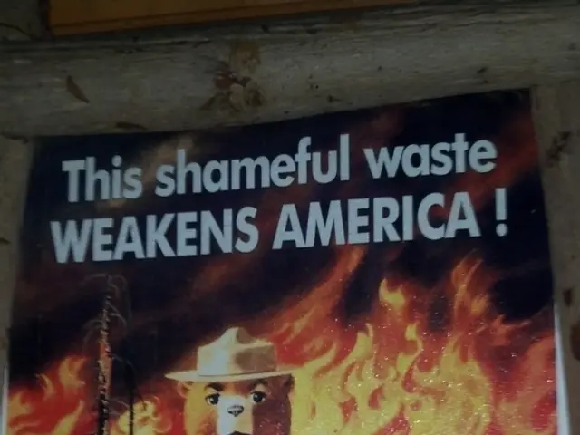 In this image in the center there is one poster stick to the wall, in that poster there is some...