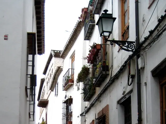 In this picture I can observe red color bike parked in this path on the left side. There are some...