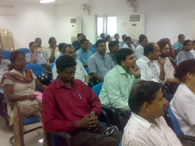 In this image I can see a group of people sitting on the chair.