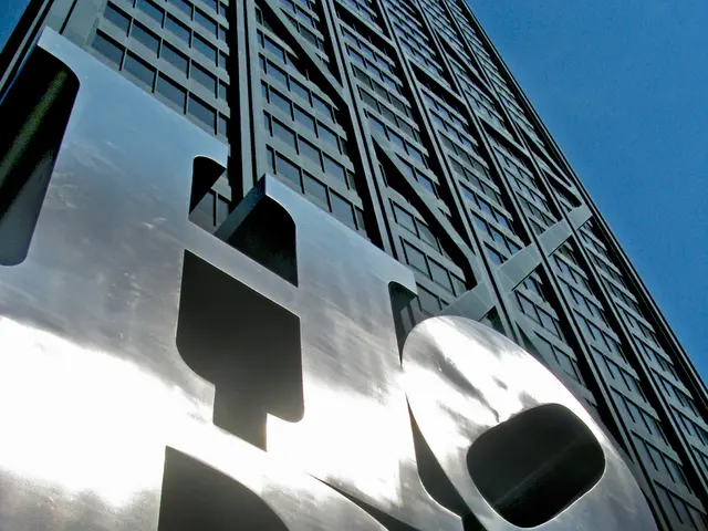 In this image there is text on the building. Right top there is sky.